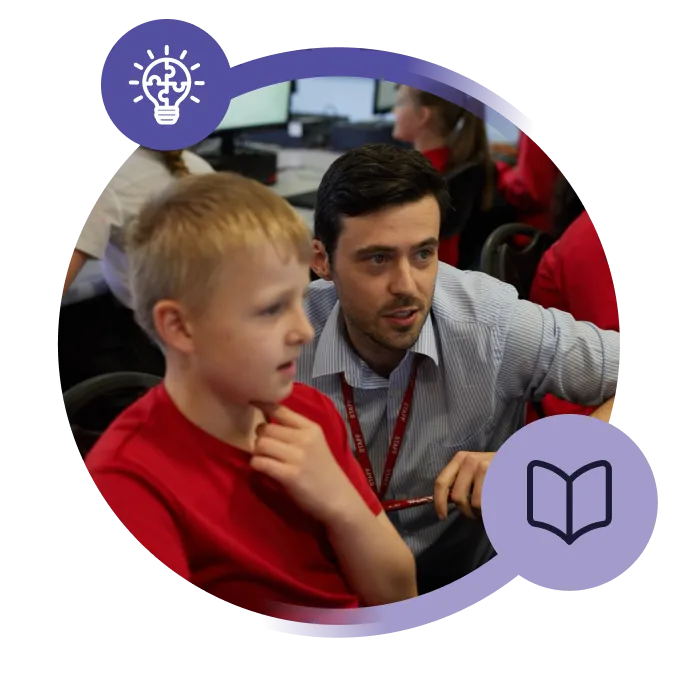 Teacher helping a pupil at a computer